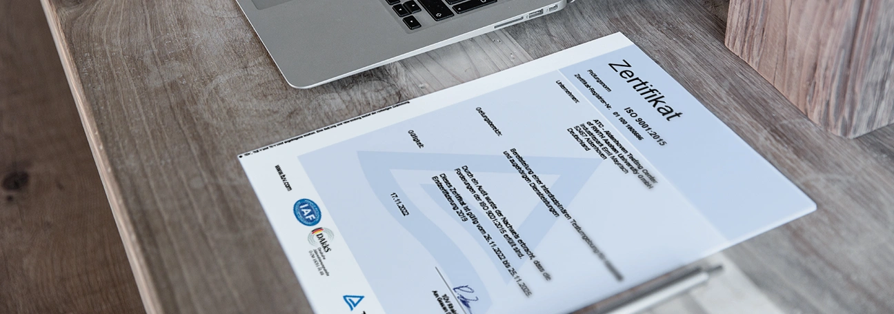 [Image: Certificate on table]