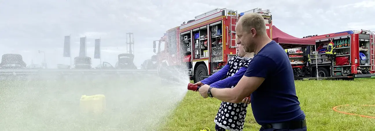 [Child holding a fire hose]